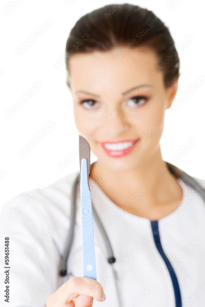 Attractive young female doctor with scalpel. Attractive young female doctor with scalpel.