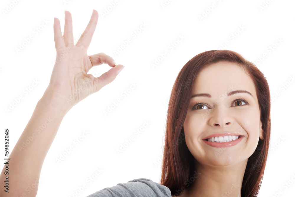 Beautiful young and casual girl is showing ok gesture. Beautiful young and casual girl is showing ok gesture.