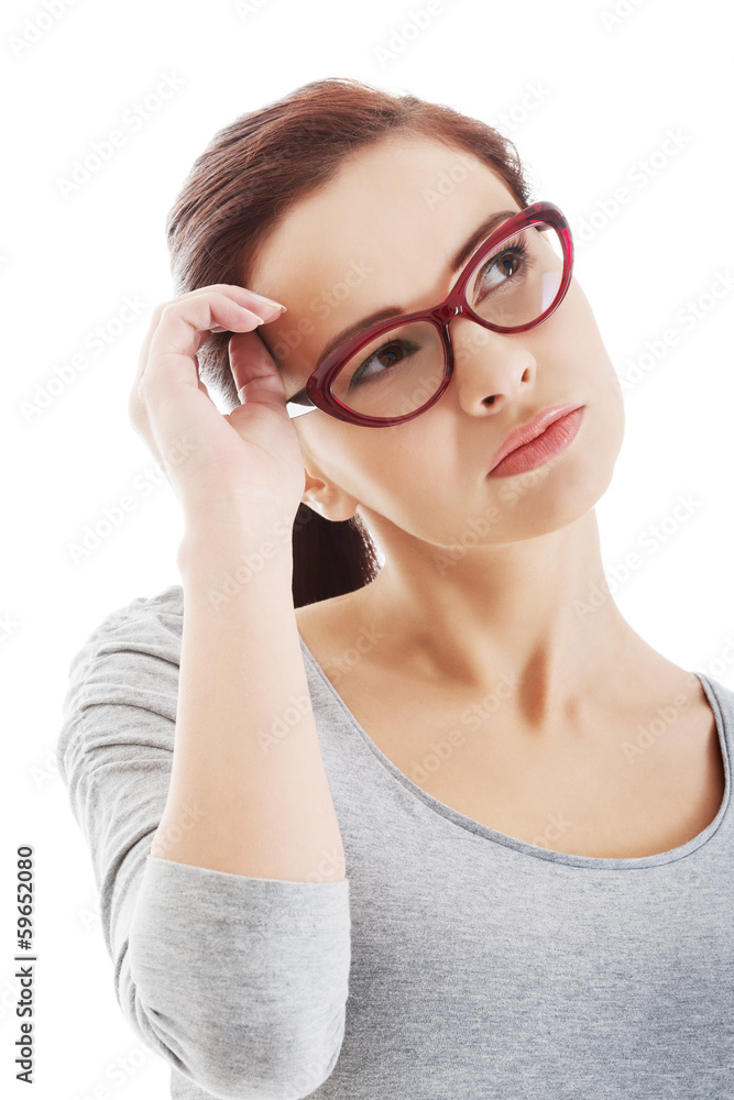 Portrait of thoughtful woman in eyeglasses.