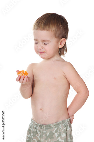 Portrait of a little boy grimacing on white background