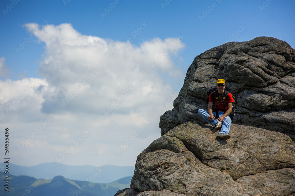 a tourist on a rock