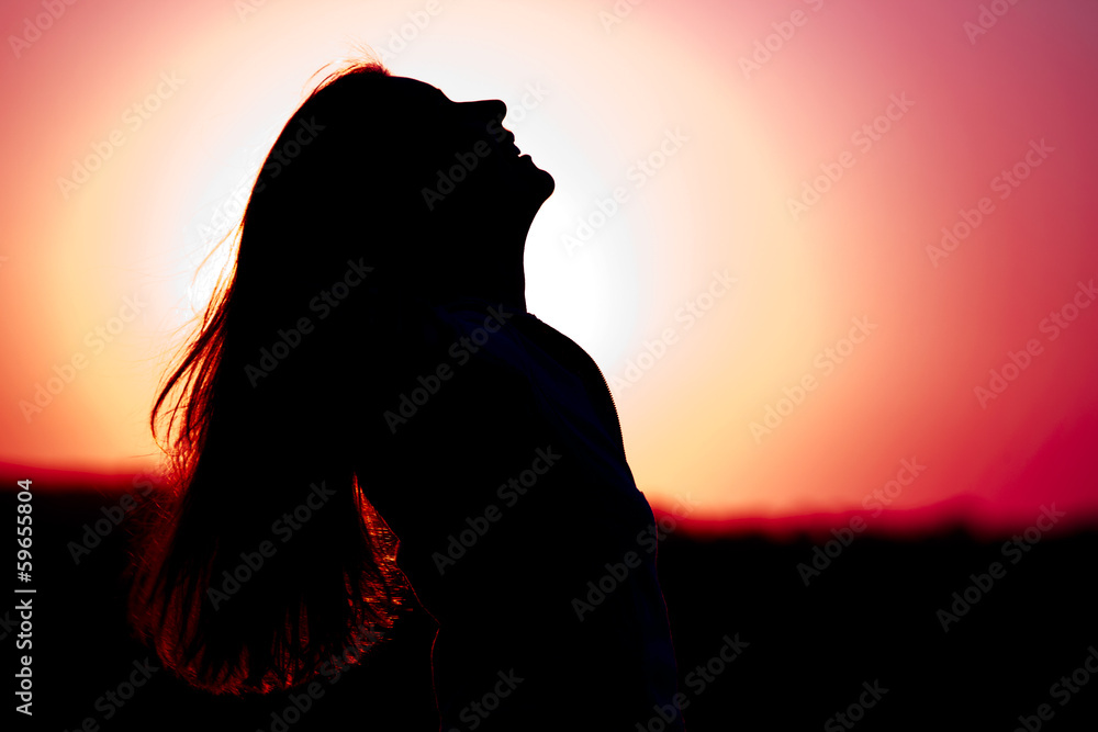 Woman relaxing at sunset
