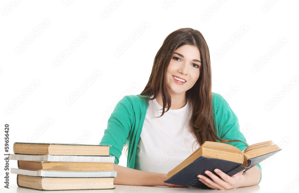 Young beautiful student sitting with book, reading, learning. Young beautiful student sitting with book, reading, learning.