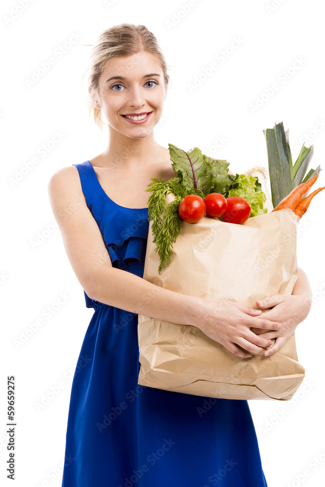 Beautiful and attractive woman carrying a bag full of vegetables Beautiful and attractive woman carrying a bag full of vegetables