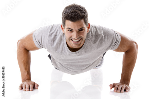 Handsome young man making pushups photo