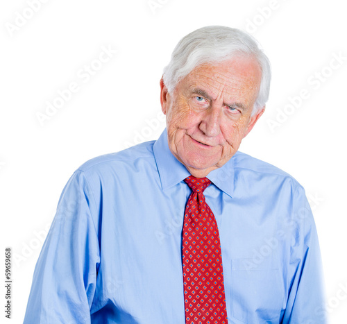 Elderly businessman with glasses skeptically looking at you 