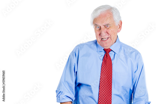 Elderly businessman with glasses skeptically looking at you 