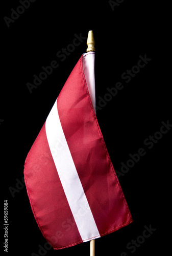 National flag of Latvia isolated on black