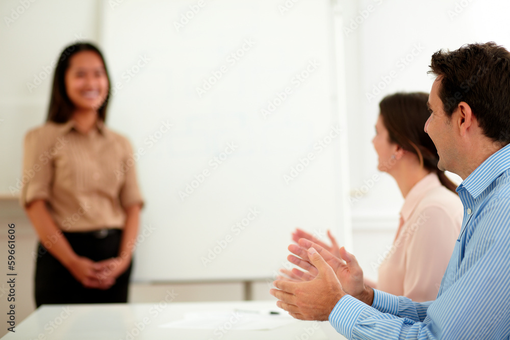 Male and female colleagues giving applause Male and female colleagues giving applause