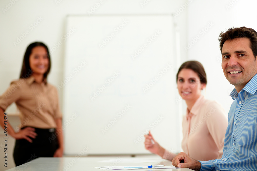 Professional colleagues smiling and looking at you Professional colleagues smiling and looking at you