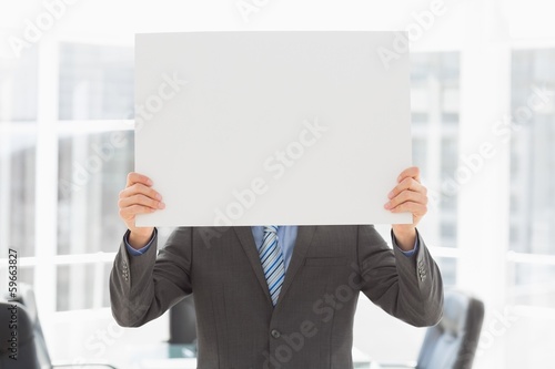 Businessman holding placard over his face © WavebreakmediaMicro