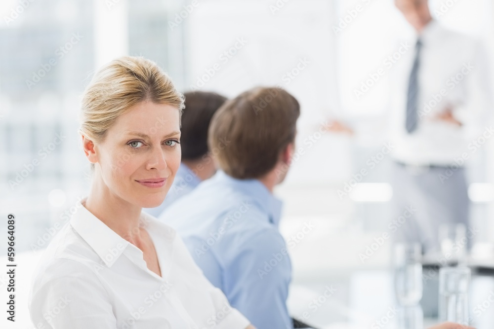 Businesswoman smiling at camera during a meeting Businesswoman smiling at camera during a meeting