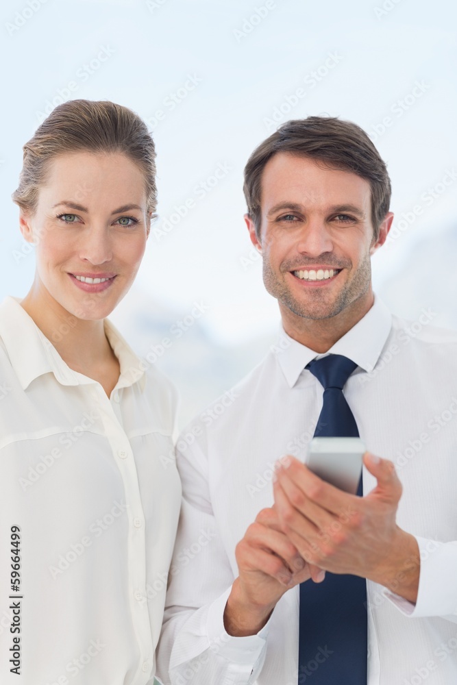 Smartly dressed colleagues with a mobile phone Smartly dressed colleagues with a mobile phone