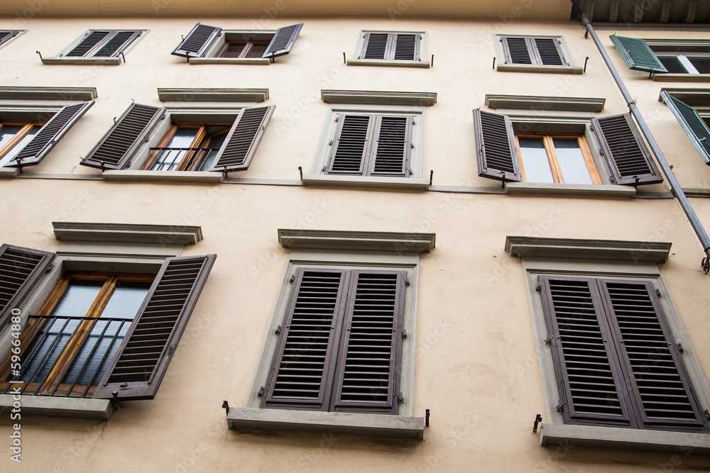 Fototapeta premium Old Plaster Building with Brown Shutters