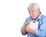 Old man holding, petting piggy bank. Financial decisions