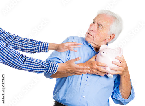 Fotografija Senior man protecting piggy bank, savings from being stolen