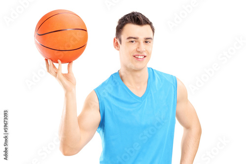 Basketball player holding a basketball and posing