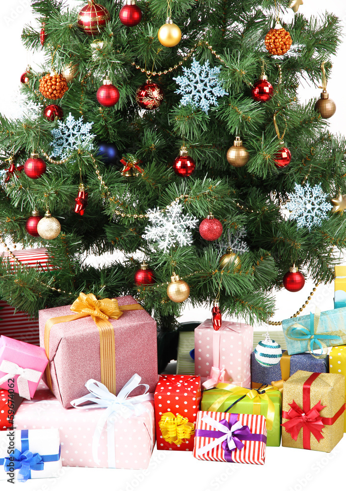 Decorated Christmas tree with gifts isolated on white Decorated Christmas tree with gifts isolated on white