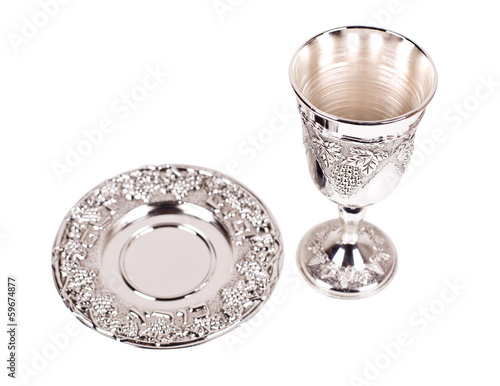 Silver kiddush wine cup and saucer on a white background photo