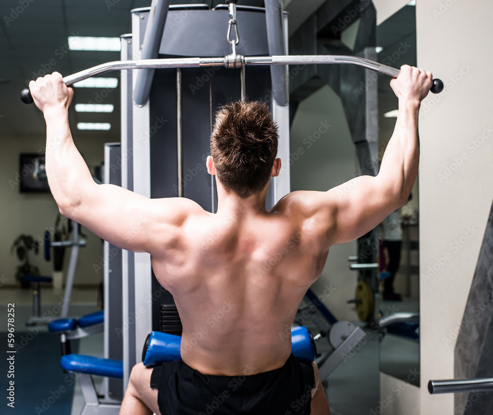 Fototapeta premium bodybuilder with simulator