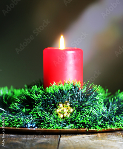 Burning candle and Christmas decorations