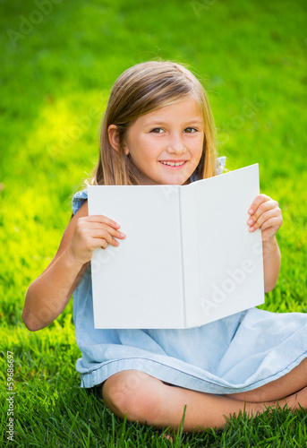 Adorable cute little girl reading book