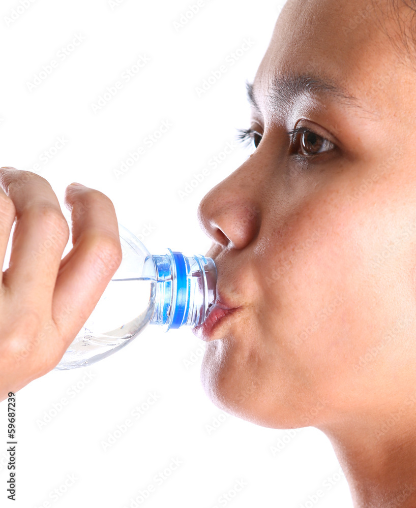 Female drinking mineral water over white background Female drinking mineral water over white background