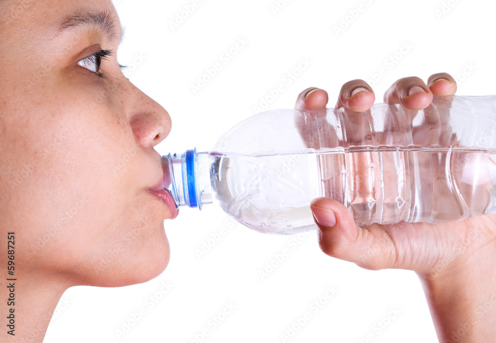 Female drinking mineral water over white background Female drinking mineral water over white background