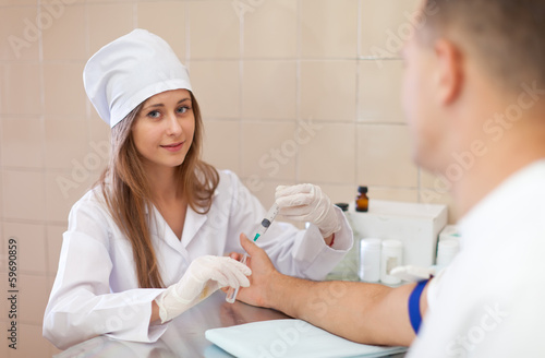  nurse prepares to make an intravenous injection