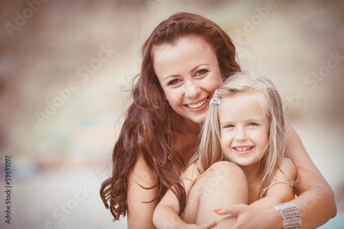 Happy family resting at beach in summer