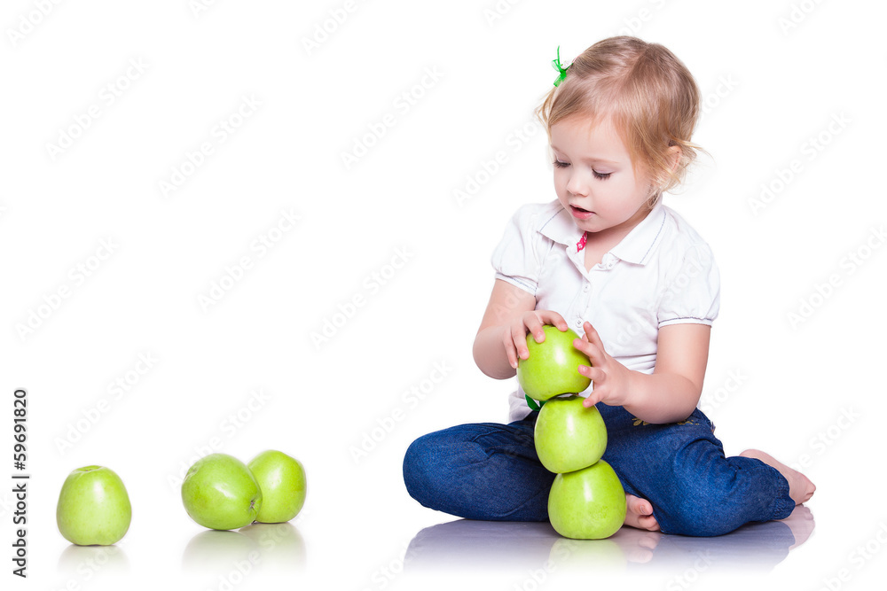 Adorable little girl sitting with green apples Adorable little girl sitting with green apples