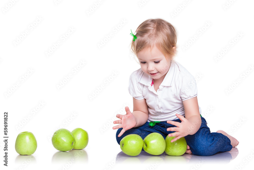 Adorable little girl sitting with green apples Adorable little girl sitting with green apples