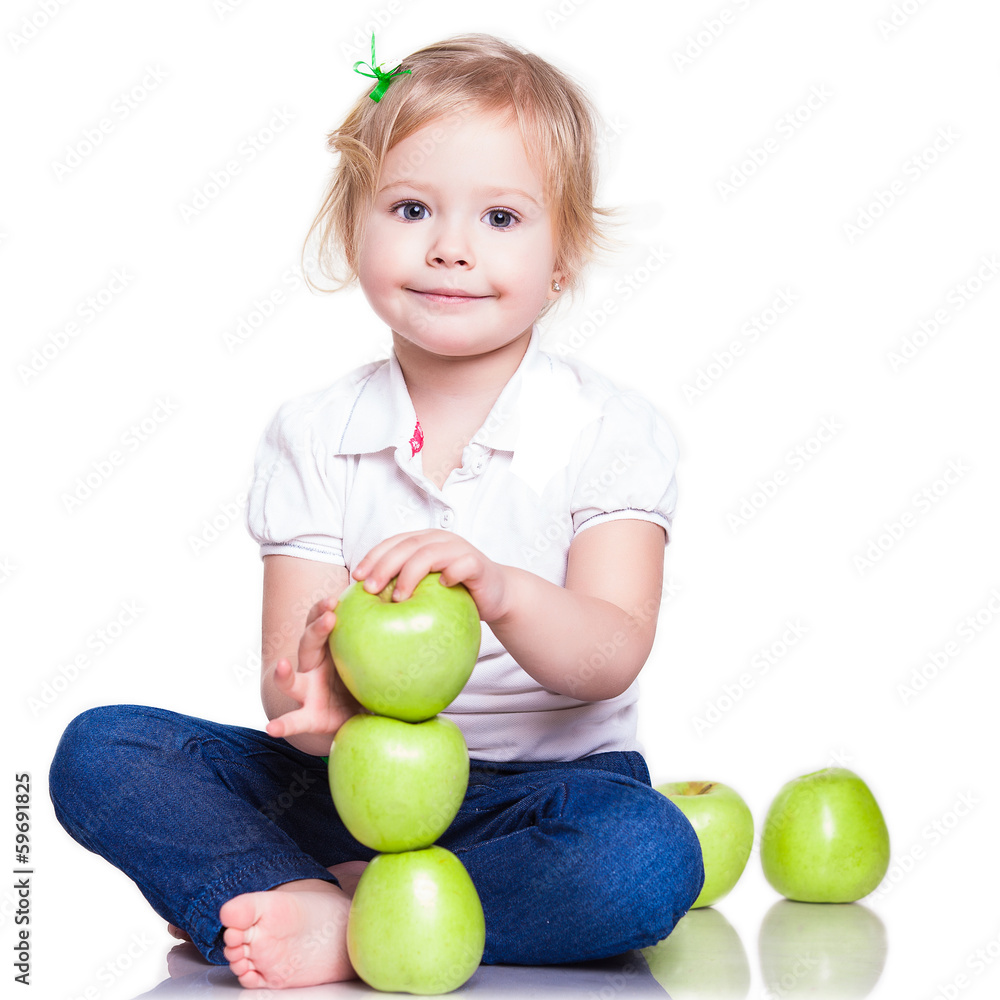 Adorable little girl sitting with green apples Adorable little girl sitting with green apples