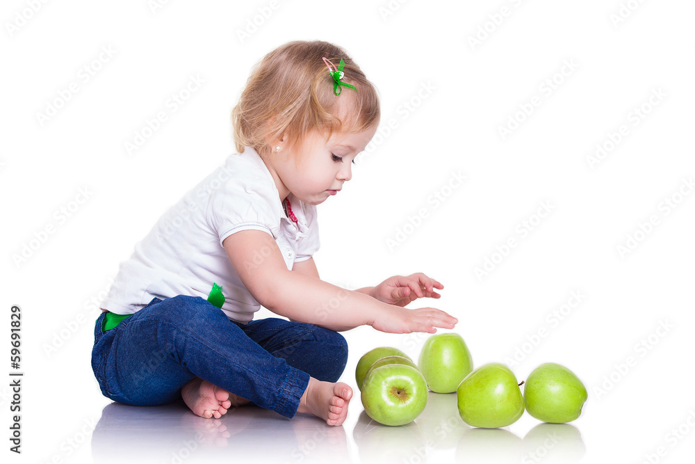 Adorable little girl sitting with green apples Adorable little girl sitting with green apples