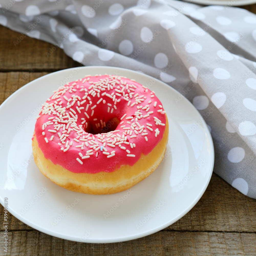 round donut with pink icing round donut with pink icing