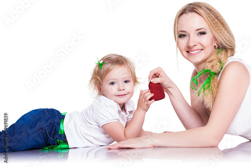 portrait of young mother and little daughter holding heart