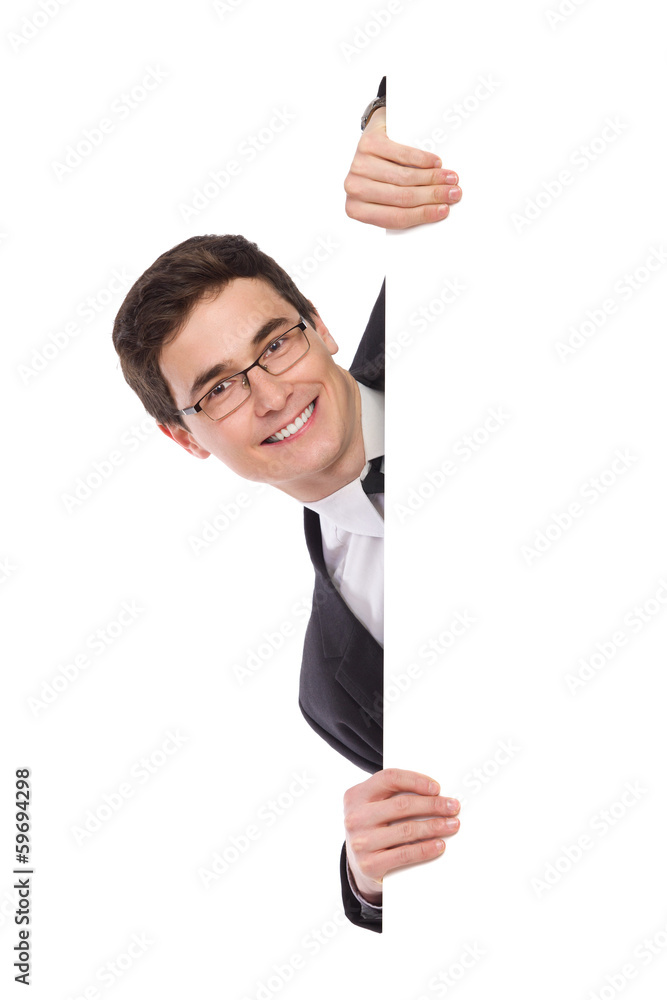 Happy business man peeking behind a banner. Happy business man peeking behind a banner.