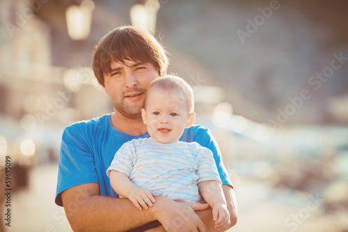 father and little daughter playing on the waterfront