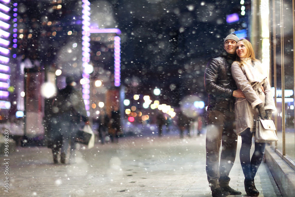 Love man and woman embracing outdoors winter snowfall Love man and woman embracing outdoors winter snowfall