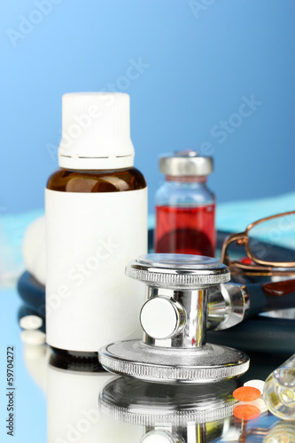 medicines and a stethoscope on a blue background close-up