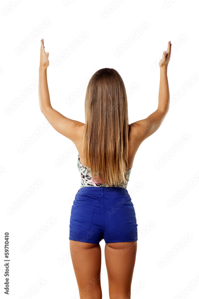 rear view of a girl holding imaginary object over her head rear view of a girl holding imaginary object over her head