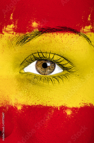 spain flag painted over female face