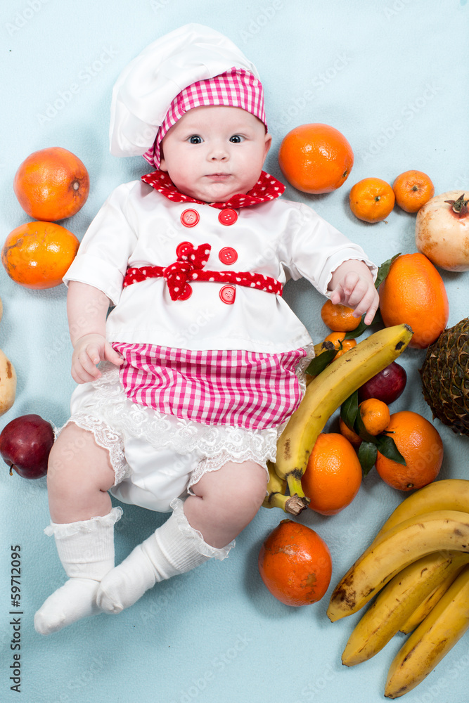 Baby cook girl wearing chef hat with fresh fruits. Baby cook girl wearing chef hat with fresh fruits.