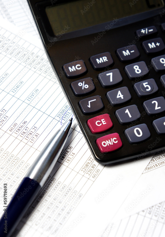 Office table with calculator, pen and accounting documents Office table with calculator, pen and accounting documents