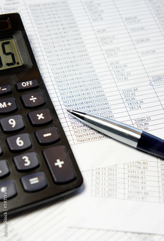 Office table with calculator, pen and accounting document Office table with calculator, pen and accounting document