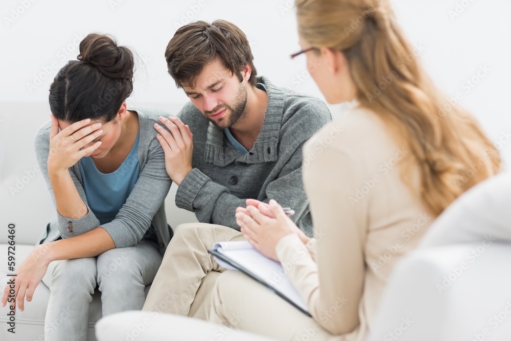 Displeased couple in meeting with a financial adviser Displeased couple in meeting with a financial adviser