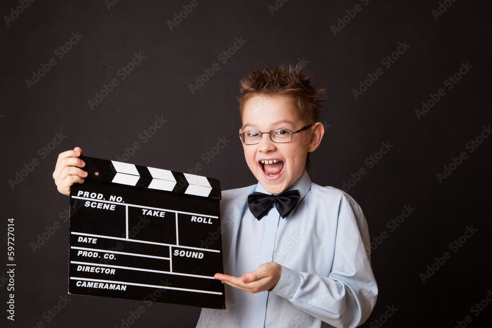 Little boy holding clapper board in hands. Little boy holding clapper board in hands.