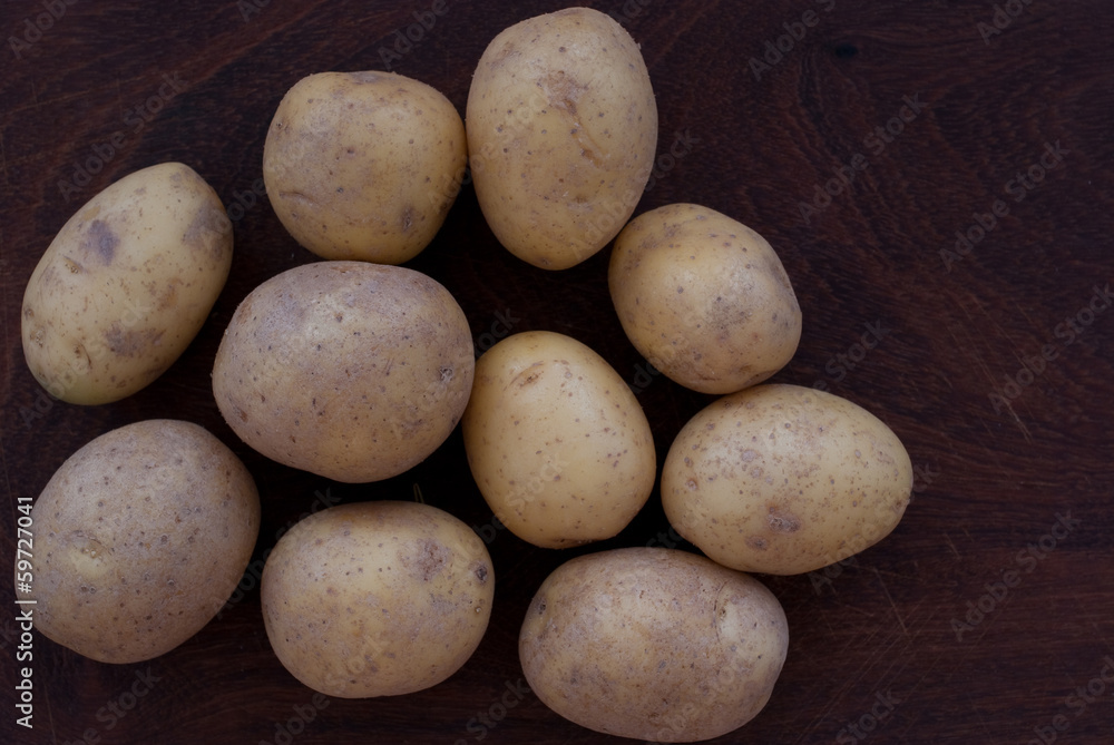 Potatoes on wooden background - studio shot from above Potatoes on wooden background - studio shot from above