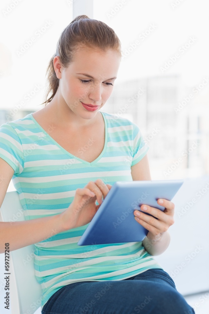 Beautiful young casual woman using digital tablet Beautiful young casual woman using digital tablet