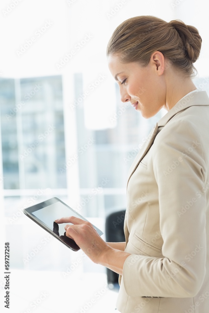 Beautiful businesswoman using digital tablet in office Beautiful businesswoman using digital tablet in office